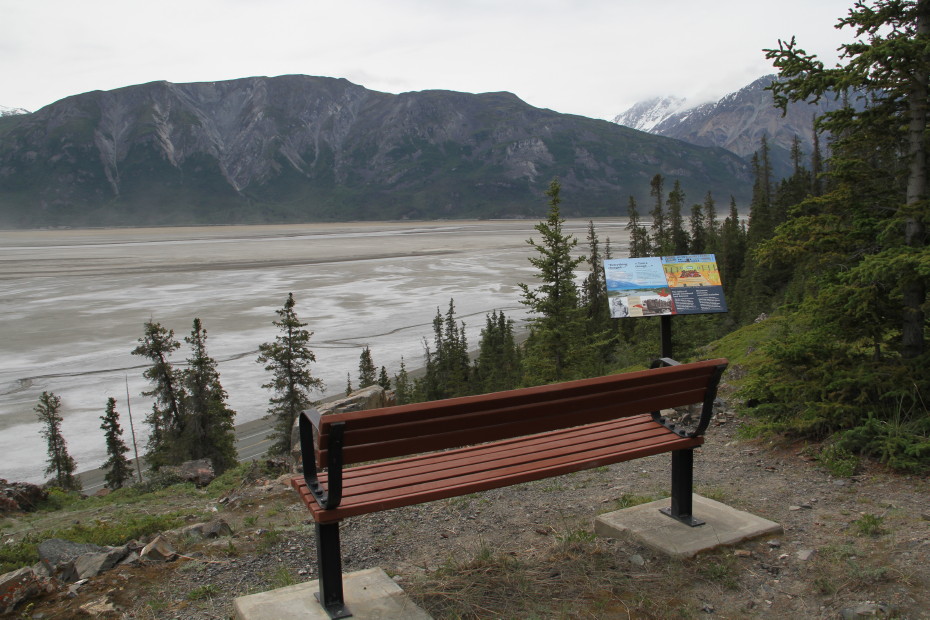 A photo of a bench overlooking the Slims River Flats, and the interpretive panel there