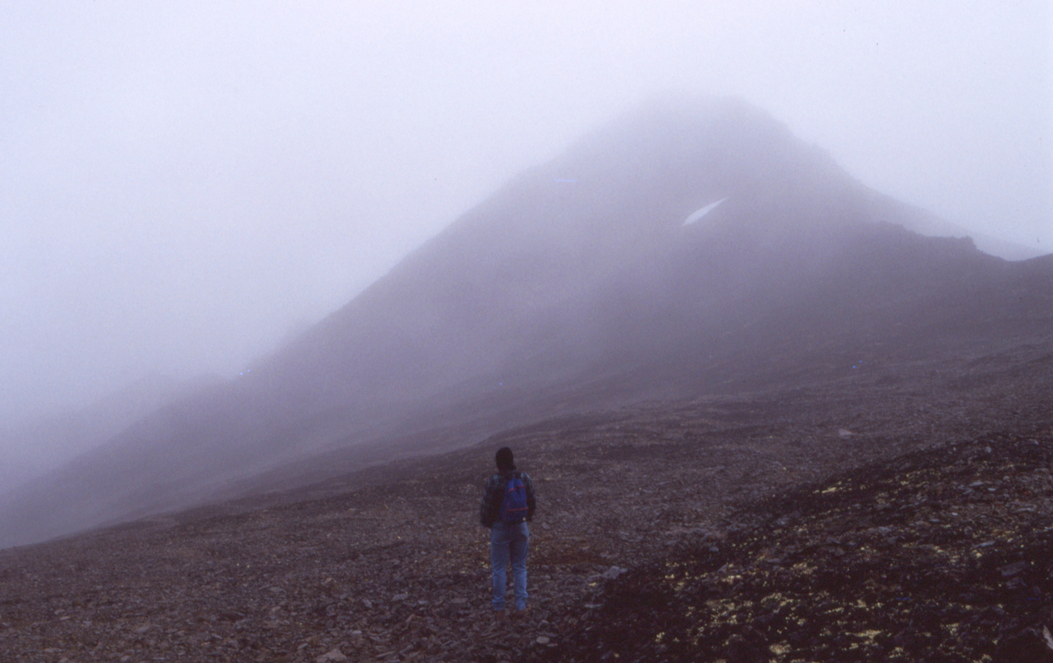 A hiker on the Montana Mountain Peak trail, in the clouds