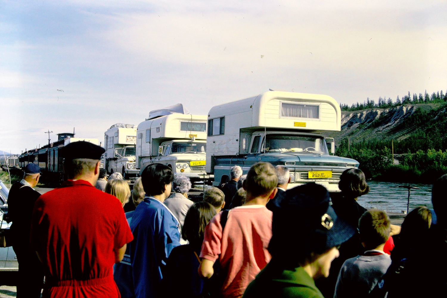 Camper trucks ontWhite Pass & Yukon Route railway flatcars at Whitehorse, July 1966