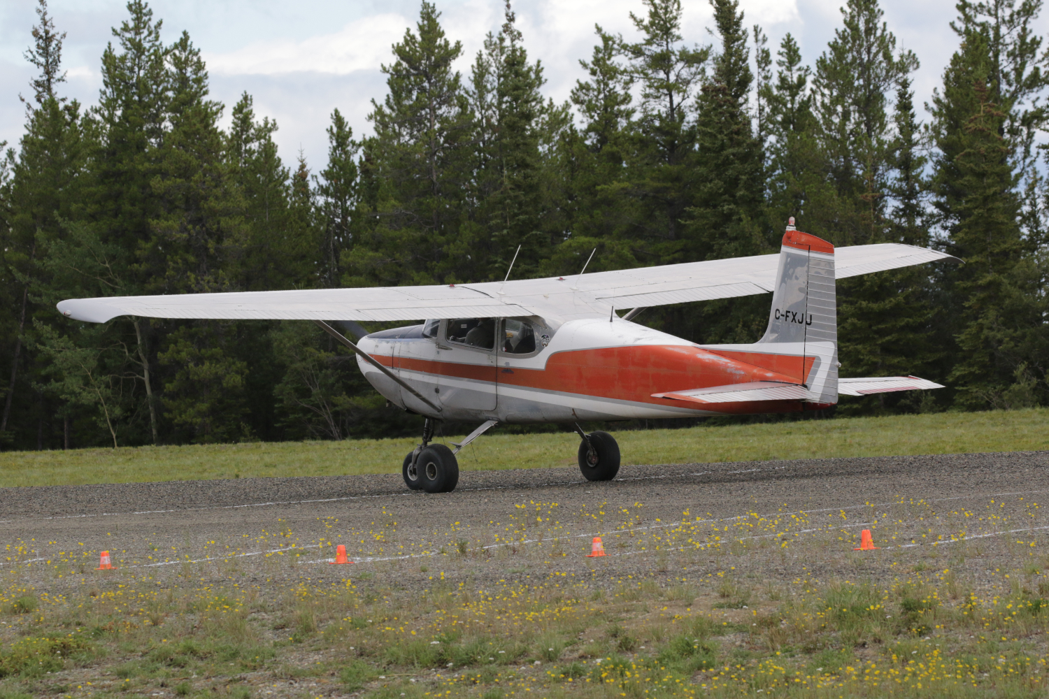 A photo of C-FXJJ, a 1957 Cessna 172, at Cousins Airport, Yukon (CFP8), on July 25, 2026.