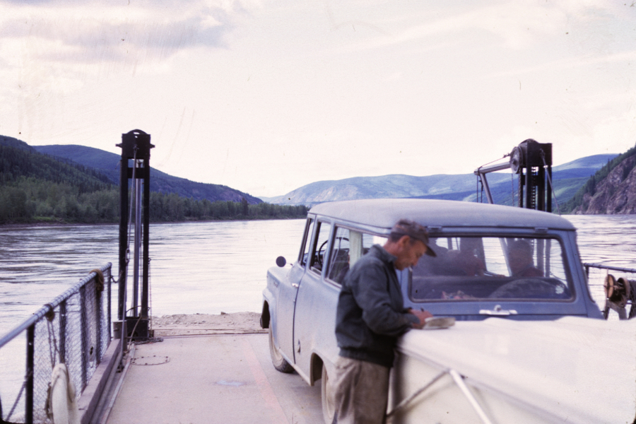 An International Travelall and popup trailer on the Yukon River ferry at Dawson. Photo shot in 1966 - digital image donated to ExploreNorth by Michael Drews in 2025.