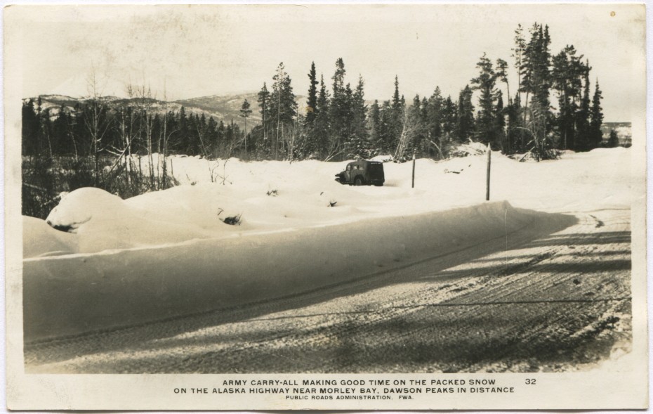Alaska Highway postcard showing an Army carryall on the road in the winter, 1940s
