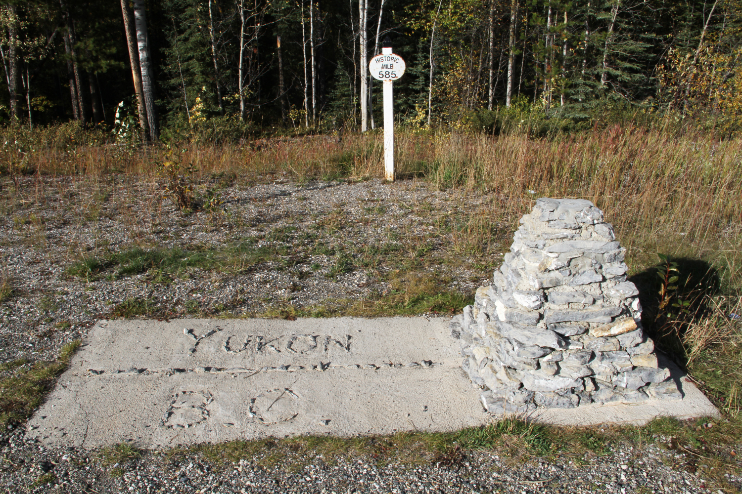 Unofficial Yukon/BC border monument at Km 905 / Historic Mile 585 on the Alaska Highway