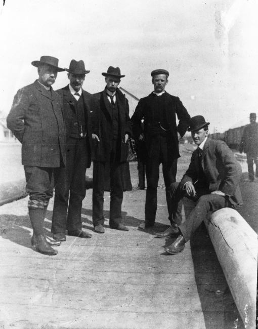 A group of men on Front Street north of the railway depot at Whitehorse, Yukon Territory, 1900